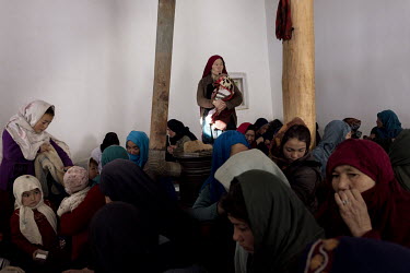 Women waiting, with their children, for their turn to see a health worker from an UNICEF mobile team visiting the village of Mirane Rostam, a day's travel from the city of Bamiyan. UNICEF is there to...