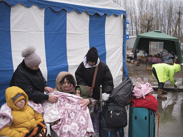 Refugees who have crossed from Ukraine at the Palanca border point wait for onward tranportation.