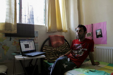 Ali Reza sits on his bed at home in Kayseri. After leaving Iran because he said life was too difficult for a gay man, he waited for resettlement in Turkey. Ali has been resettled in North America.