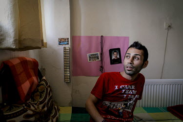 Ali Reza sits on his bed at home in Kayseri. After leaving Iran because he said life was too difficult for a gay man, he waited for resettlement in Turkey. Ali has been resettled in North America.