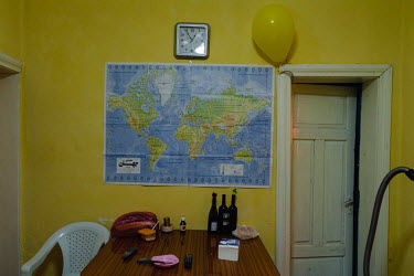 A map of the world on a living room wall of the home shared by three gay Iranian refugees (Shahin, Arash and Arsham).