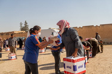 Bread and basic food parcels are distributed to people in Tabia village by staff working for AFAD (Disaster and Emergency Management Presidency), a Turkish NGO which, alongside the Turkish Red Crescen...