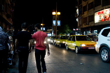 Bissam (left) and Abdul (right) walk the streets of Damascus together at night, when the gay community became more visible on the streets. Both Abdul and Bissam are gay Iraqi men who feared for their...