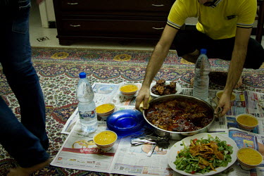 Abdul (right) and Bissam (left) prepare an Iftar meal on a Ramadan evening at Abdul's apartment. Both men are from Baghdad, Iraq and were forced to flee the country due to reasons, and threats, connec...