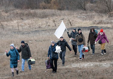 A group of civillians walk over fields towards Kiev (Kyiv) from the suburb of Irpin under white flags as residents continue to try and evacuate the suburb that has been heavily bombed by invading Russ...