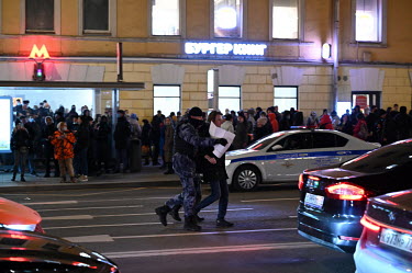 Police frog-march a protestor across a road as a crowd gathered in central Moscow to show their opposition to the invasion of Ukraine.
