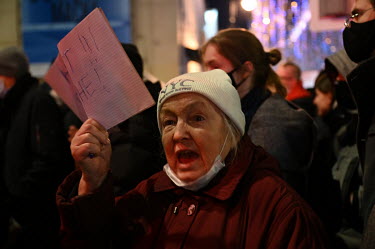 An elderly woman holds a sign, during a protest in central Moscow against the invasion of Ukraine, that reads: 'No War WIth Ukraine'.