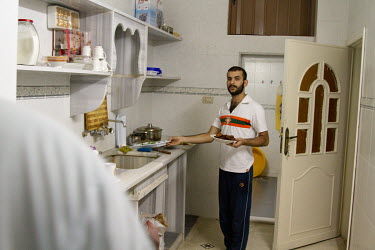 Abdul prepares an Iftar meal during a Ramadan evening at his apartment.   Originally from Baghdad, Iraq, he was forced to flee the country due to reasons, and threats, connected with his homosexuality...