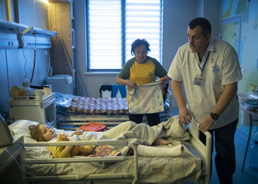 A medic checks the dressing on six year old Milana's right leg at the Okhmadyt Children's Hospital. Milana was seriously injured in a Russian shelling attack on the city which killed her mother. Milan...