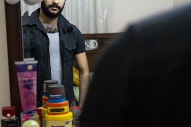 Abdul prepares to go out at night in the streets of old Damascus, something he remembers was impossible under curfew in war torn Baghdad. Originally from Baghdad, Iraq, he was forced to flee the count...