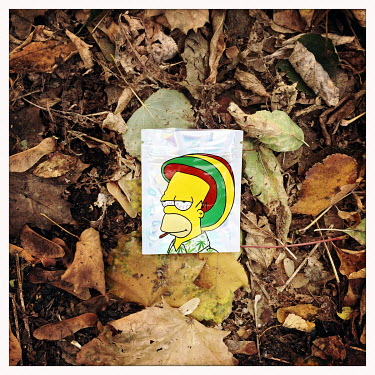 A discarded empty plastic drug 'baggie' used for for weed and featuring Homer Simpson motif.