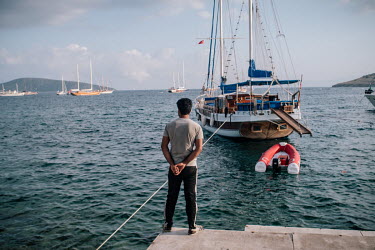 A Pakistani man stands in the harbour in Bodrum, Turkey looking towards the Greek island of Kos. He plans to smuggle himself into the EU with other Pakistani migrants.