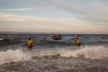 Spanish lifeguards guide a boat of migrants and refugees to land on the Greek island of Lesvos.