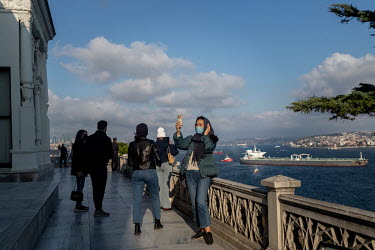A foreign tourist takes a selfie outside the Topkapi Palace, during a nationwide weekend coronavirus curfew which didn't apply to overseas visitors.