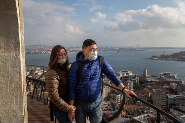 Visiting Turkey from Moscow, Bagrta Kalachinova (left) and her husband Denis Kalachinova (right) taking in the spectacular views of Istanbul from the Galata Tower, during a nationwide weekend coronavi...