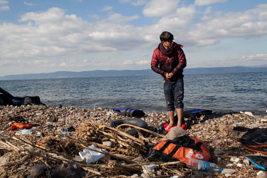 An Afghan man stands on the beach where he arrived by dinghy from Turkey, on a stretch of coastline near Molyvos.