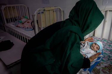 Mahgol with her baby (1 month) who was born with asthma and was premature, very likely due to the mother's malnutrition at the main hospital in Herat city where children suffering from severe acute ma...