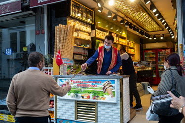 Foreign tourists buy ice creams on Istiklal Street during a nationwide weekend coronavirus curfew which didn't apply to overseas visitors.
