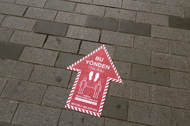 A sticker on Istiklal Street, one of Istanbul's most well known shopping avenues, instructs people to walk on one side of the street, in an attempt to stop the spread of COVID-19.