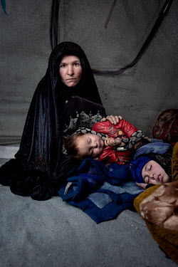 Gulstan and her family have fled their home village because they ran out of food. Their hunger has taken them to this little camp of simple tents on the outskirts of Herat city.  Her two daughters, Fa...