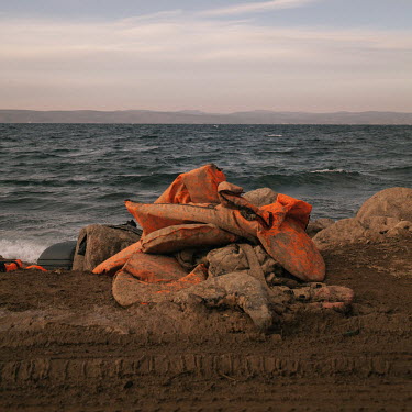 A pile of discarded life vests used by informal migrants who recently smuggled themselves across the Aegean Sea from mainland Turkey to Greece.