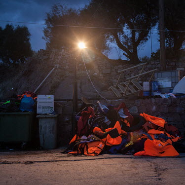 A large pile of discarded life vests used by informal migrants who recently smuggled themselves across the Aegean Sea from mainland Turkey to Greece, collected from the beaches of Lesvos.