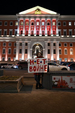 Alena, a young 'single picket' protestor, standing in front of Moscow City Hall holding a placard with the slogan: 'No war with Ukraine.