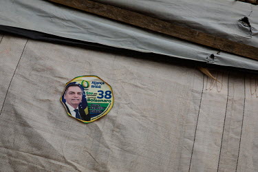 A sticker featuring President Jair Bolsonaro on the side of a shack in the Boa Esperanca encampment in Vila Rio Pardo. The camp was set up last year by landless families who were removed from an area...