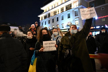 Women raise signs during a protest in central Moscow against the invasion of Ukraine that read: 'No War WIth Ukraine'.