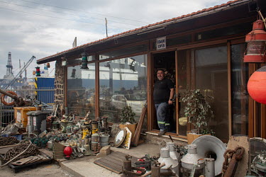 Noyan Yurtas stands in the doorway of his antique store, selling a range of salvaged items from various cruise liners and ships in the Aliaga ship-breaking yard.