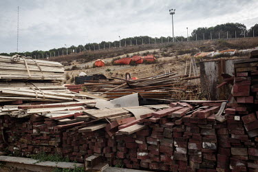 Salvaged ship's lifeboats and piles of wood in the Aliaga ship-breaking yard.