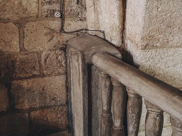 Concrete railings attached to the interior walls of the Iglesia de Santa Maria del Castillo, a 13th century Romanesque church in the village of Castronuno. The railings are part of a concrete mezzanin...