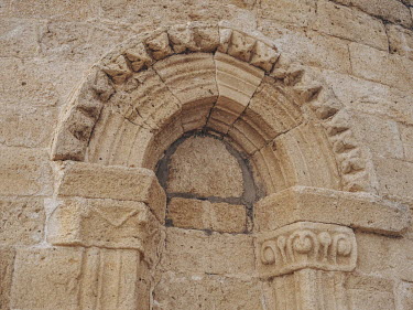 Crude cement work on a restored section of the exterior wall of the Iglesia de Santa Maria del Castillo, a 13th century Romanesque church in the village of Castronuno.