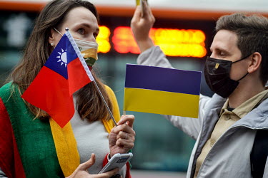 A woman holds both Taiwan and Ukrainian flags during a pro-Ukraine rally held outside the Russian representative office following the news that overnight president Putin had ordered a full-scale invas...