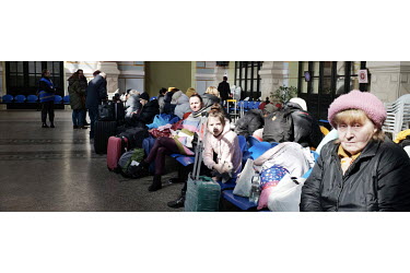 An elderly Ukrainian refugee sits at the Suceava train station waiting room for a train to Bucharest.