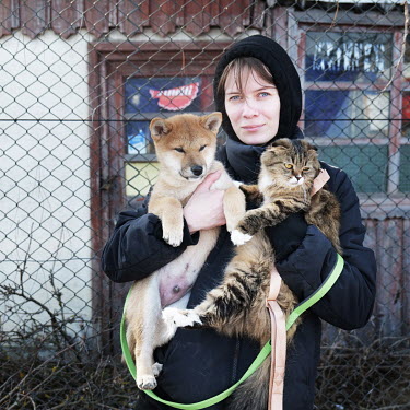 Anastasia (28), from Kyiv (Kiev), near the border crossing where she just entered Romania with her pets, a dog named Buky and a cat named Yoshi. She said 'they are part of my family so I could not aba...