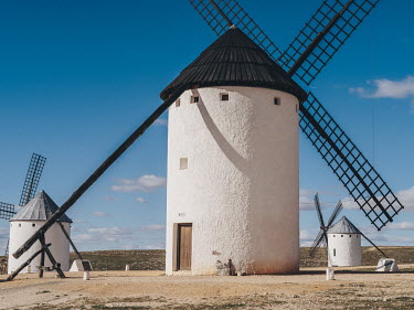 Historic windmills line a hillside overlooking the town of Campo de Criptana, the birthplace of writer Ana Iris Simon. The whitewashed structures are part of the visual iconography of the Castilla la...