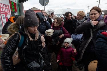 Ukrainian refugees, primarily women, children and the elderly, fleeing Russia's invasion of the country, queue for hours at the Medyka-Shehyni border crossing with Poland to reach safety.