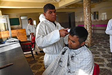 A man has his hair cut on arrival at the Ibn Sinar Addiction clinic. While traditionally heroin and opium were the most common addiction causing drugs available in the country, over the last five year...