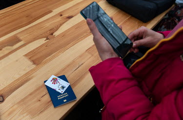 A refugee from Ukraine obtaining a Polish SIM card at staging area for refugees from Ukraine.