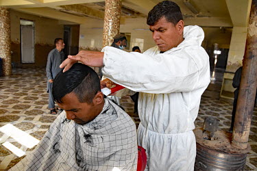 A man has his hair cut on arrival at the Ibn Sinar Addiction clinic. While traditionally heroin and opium were the most common addiction causing drugs available in the country, over the last five year...