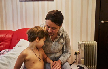 Inga Volos with one of her children, Dariy. They fled the war from their native Kharkiv on 3 March 2022 and sheltered in the Dnipro Business Apartments for six days before they continued to west Ukrai...