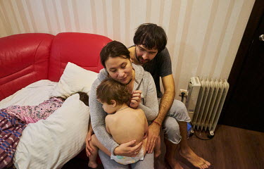 Rodina Volos (from left: sleeping Miroslava, Dariy, Inga and Ivan, baby Dan sleeps in another room) in their room in the Dnipro Business Apartments. They fled the shelling in their home town of Kharki...