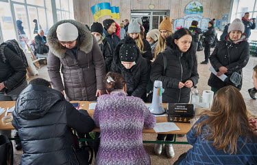 Women register and report what they are in need of at one of the city's humanitarian centres. This centre is providing help to specifically to women and children. They have supplies of clothes, shoes,...