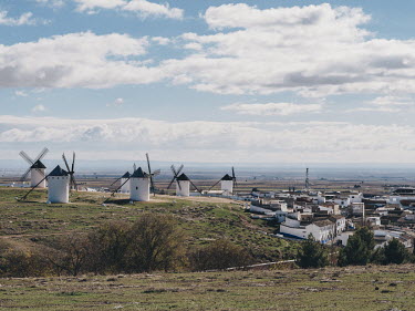 Historic windmills line a hillside overlooking the town of Campo de Criptana, the birthplace of writer Ana Iris Simon. The whitewashed structures are part of the visual iconography of the Castilla la...