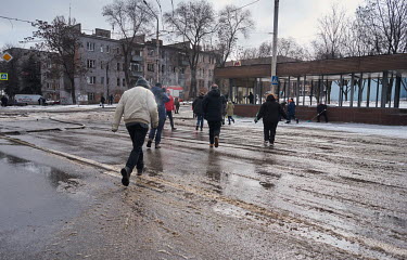 People run for shelter in the nearby Metalurhiv metro station, the nearest bomb shelter, after a warning siren alerted people that there might be an air strike.