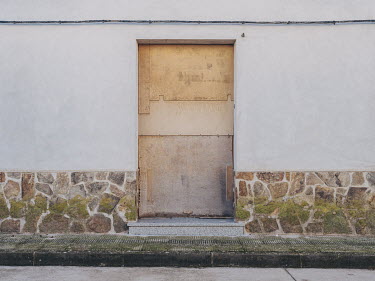A boarded up entrance to a property in an industrial area of Campo de Criptana.