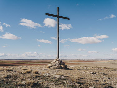 A crucifix atop a small hill adjacent to the Ermita del Cristo de Villajos, a church close to the town of Campo de Criptana.