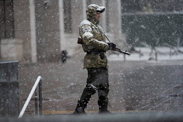 An Ukrainian guard outside a government building in the centre of Kyiv.