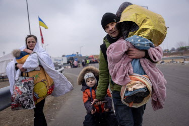 A couple arrive at the Krakovetz border crossing point with their three children where they hope to cross into Poland and safety from the Russian invasion.